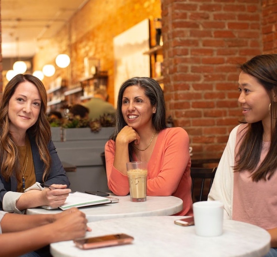 A group of women seated at a restaurant table