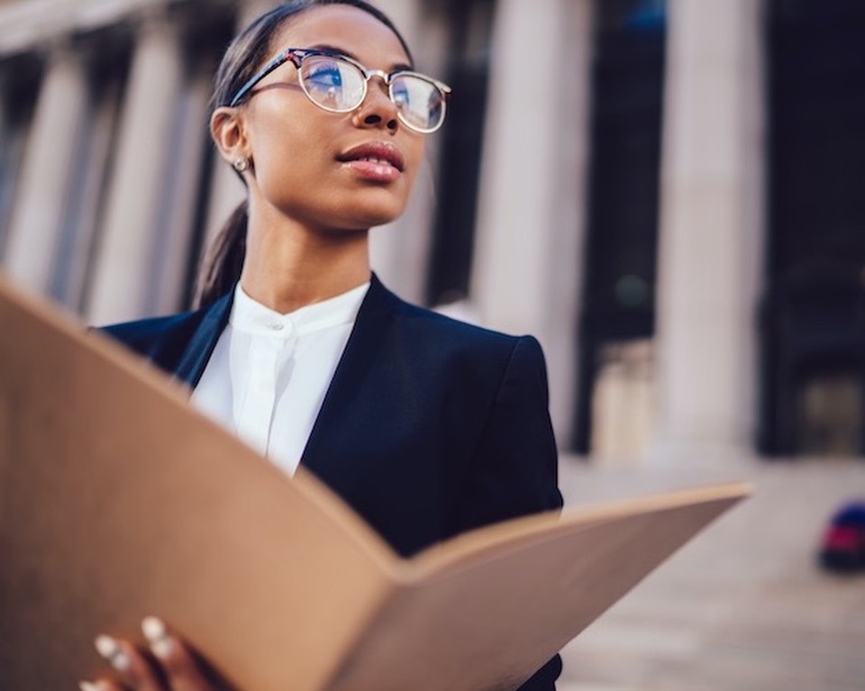 A woman holding a paper folder