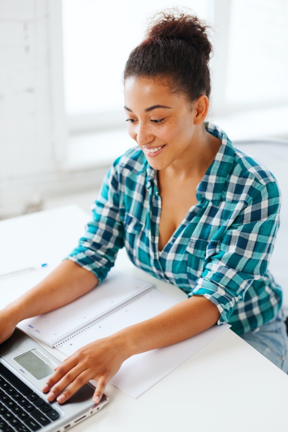 A woman typing in her laptop